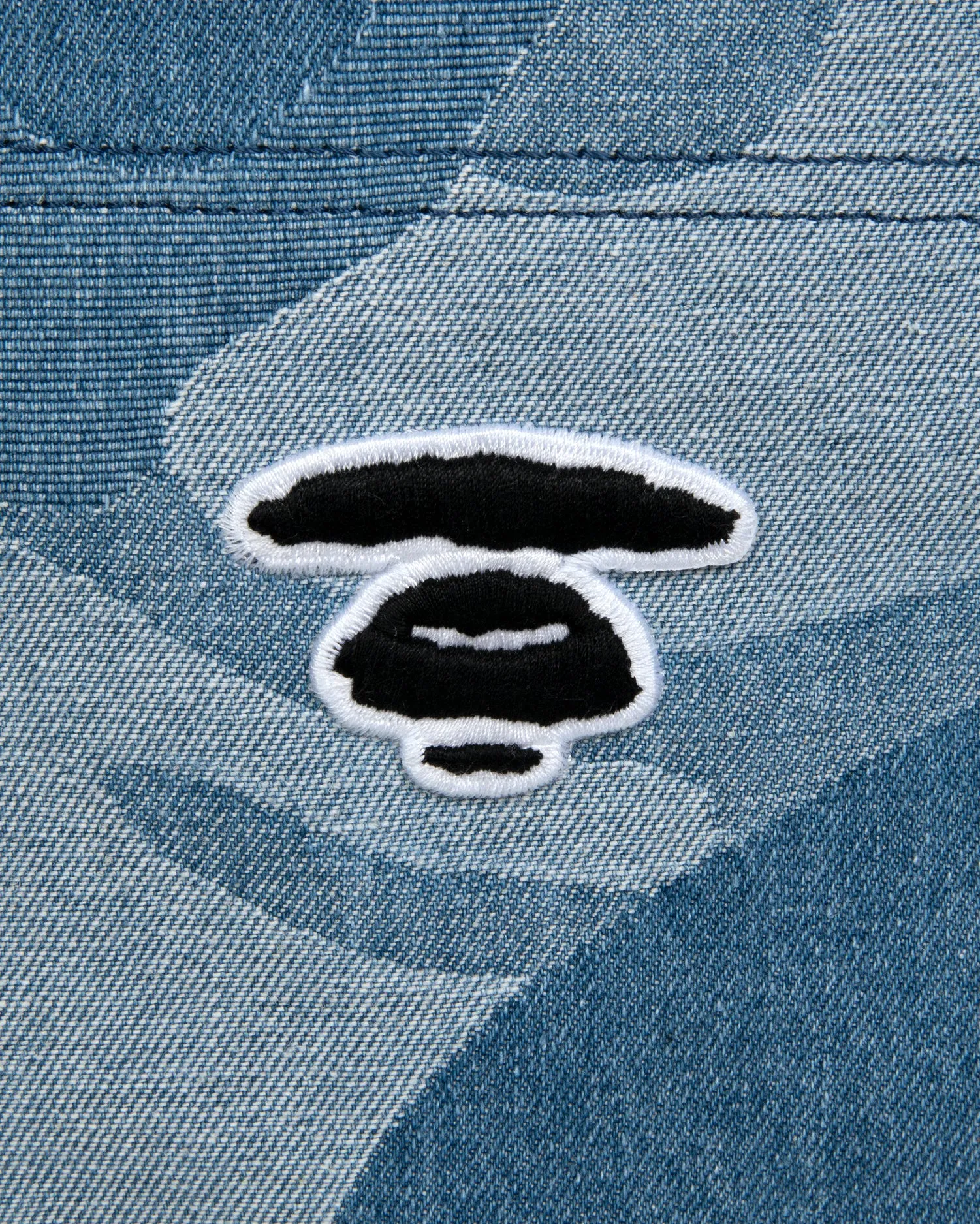 Moonface embroidered camo denim tote